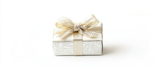 Obraz premium Small white gift box with golden ribbon placed on bright white background Copy Space