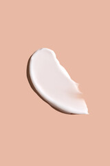 Cosmetic smear of cream texture on a beige background. Skin care.