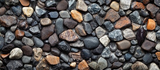 Colorful assorted pebbles and stones background texture with various shapes and sizes suitable for graphic design Copy Space