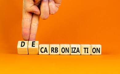 Decarbonization or carbonization symbol. Concept words Decarbonization or Carbonization on wooden blocks. Beautiful orange background. Business decarbonization or carbonization concept. Copy space.