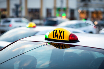 close up on taxi sign on car in the city