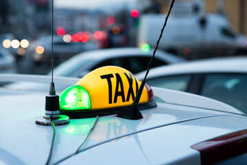 close up on taxi sign on car in the city