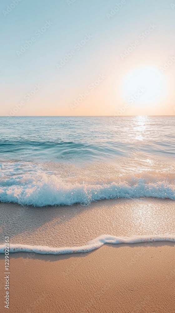Poster waves softly lap against the shoreline, leaving frothy patterns on the warm sand as the sun sinks lo