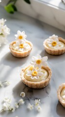 Lemon cream-filled tartlets decorated with sugar flowers in soft sunlight