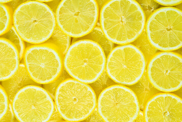 A slices of fresh juicy yellow lemons.  Texture background, pattern.