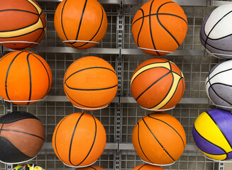 Obraz premium Close up picture of basketball game balls arranged in shelves in a store. Outdoor balls arranged in shelves in a store 