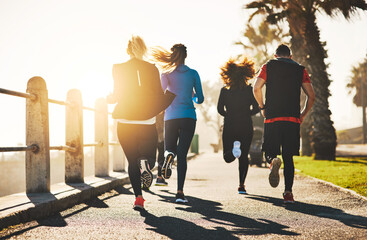 Group, back and running with team for fitness, cardio workout or exercise together on promenade....