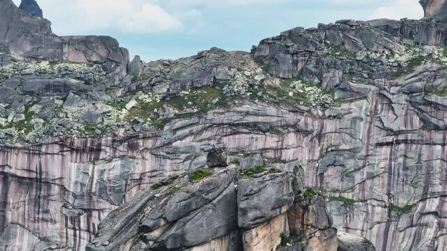 Hikers exploring majestic mountain peaks in ergaki nature park