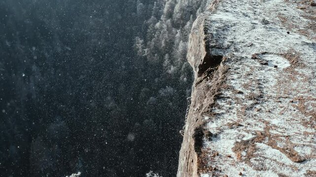 Snow falling down a cliff - view from Tomasovsky Vyhlad in Slovakia on a sunny winter day