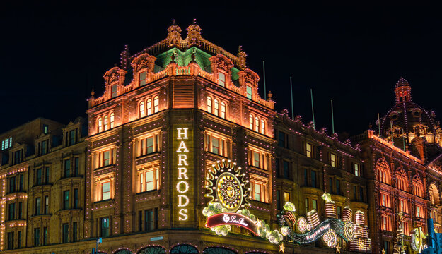 London, United Kingdom - November 25, 2024: Harrods iconic department store in the dark, Christmas illumination and decorations.