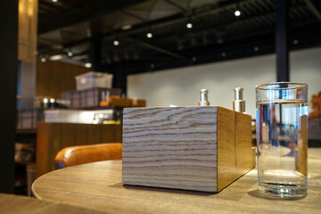 Napkin holders and other utensils on a table in a restaurant