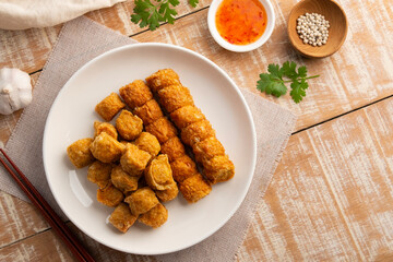 Deep Fried Chicken Rolls in white plate.with chilli sweet sauce.(Hoi Jo).Top view.