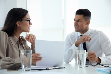 Office employees talking at table during meeting