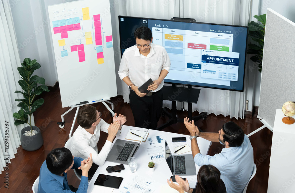 Leinwandbilder Project manager communicate and collaborate with team using project management software display on monitor, tracking progress of project task and making schedule plan at meeting table. Prudent