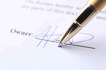 Pen leaving signature on contract, closeup view