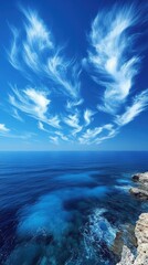 Fototapeta premium Vivid Blue Seascape with Wispy Clouds