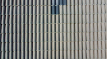 Grey roof tiles arranged in a regular pattern, creating a textured and uniform surface
