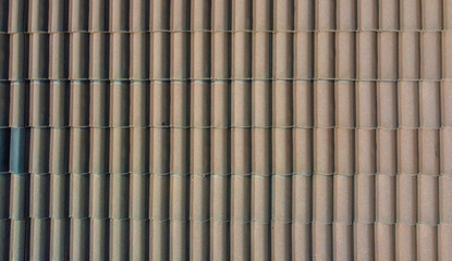 Grey roof tiles arranged in a regular pattern, creating a textured and uniform surface