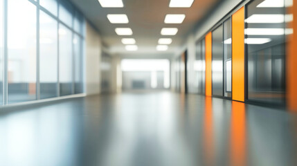 Fototapeta premium Modern office interior with blurred background featuring glass partitions and orange accents