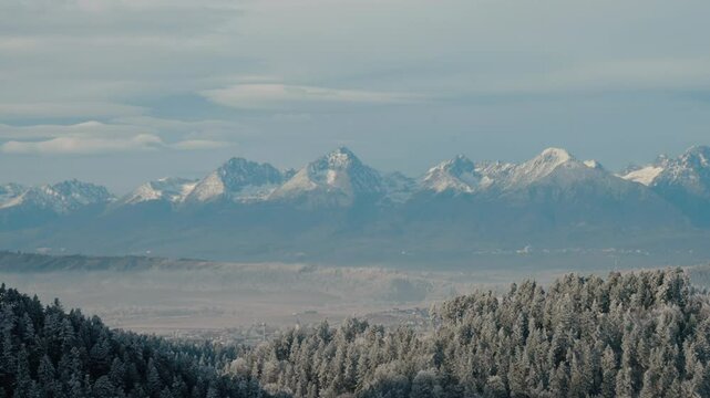 Timelapse of Vysoke Tatry mountains in Slovakia - telephoto lens view from Tomasovsky Vyhlad on a sunny winter day