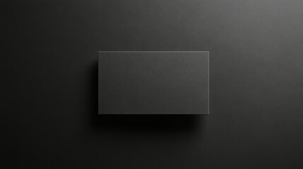 Minimalist grey card mockup centered on deep black background with soft lighting