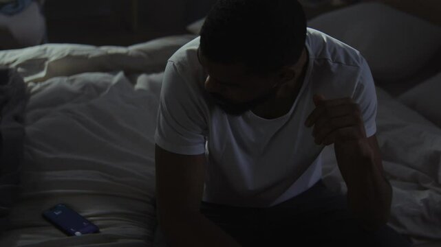 Sad black man ignores calls trying to survive breakup