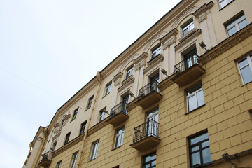 As I gaze upwards at a tall building adorned with numerous windows
