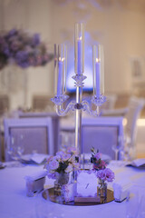 Beautiful Flower and candle decoration of wedding tables. Banquet table setting and decoration. Cutlery on the table. Tables set for an event party. Luxury elegant table setting dinner in a restaurant