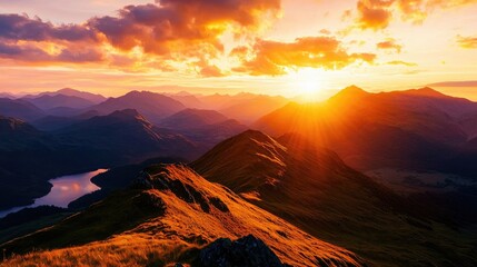 Obraz premium Majestic Sunrise Over Mountain Range With Clouds and Water Reflection