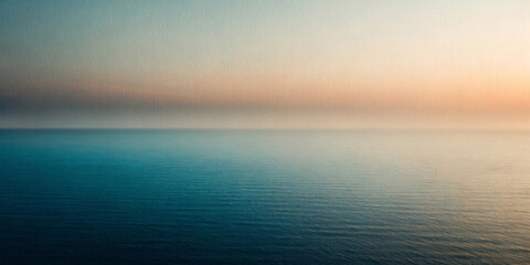 Obraz premium A serene seascape features calm waves stretching to the horizon under a soft gradient sky transitioning from blue to peach. The composition evokes a sense of tranquility and endlessness.AI