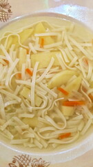 Noodles in chicken broth with herbs