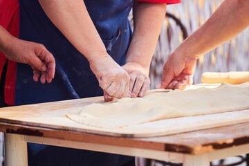 The cook's hands when working with the dough.