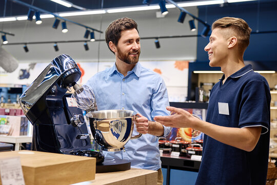 A customer discusses stand mixer features with a knowledgeable sales associate instore