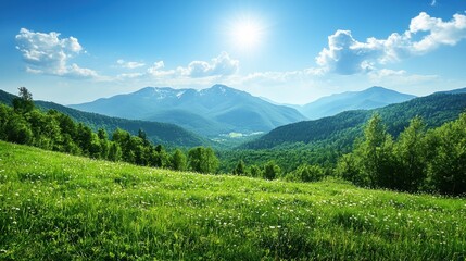 Obraz premium Sunlit mountain range with verdant valley under clear blue sky
