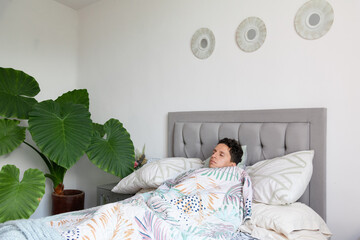 Man asleep on a bed in a room