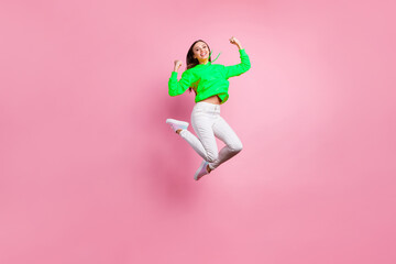 Full length body size photo of charming cheerful cute attractive girl having won some competitions while wearing yellow sweater footwear isolated over pink pastel background