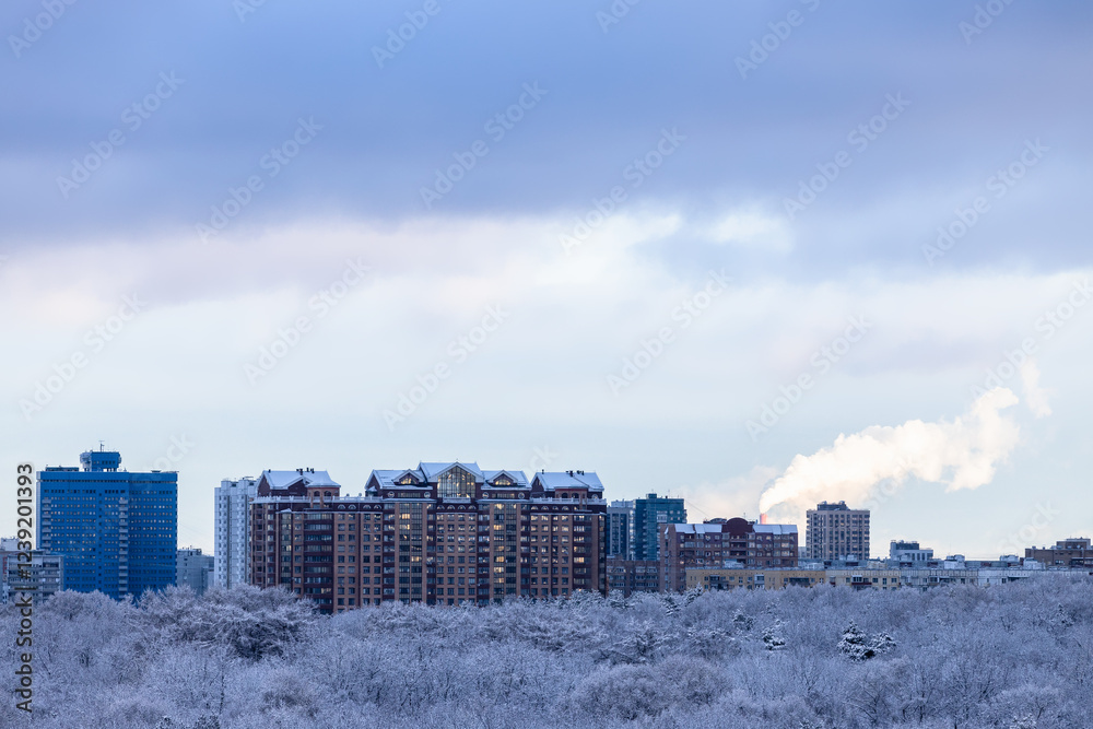 Wall mural snow cloud over modern high-rise houses in winter