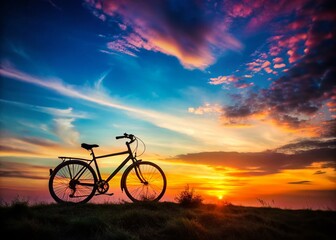 Naklejka premium Silhouette of Bicycle Rider at Sunset - Dramatic Documentary Photography