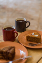 Two pieces of pie and a two mugs of hot black coffee