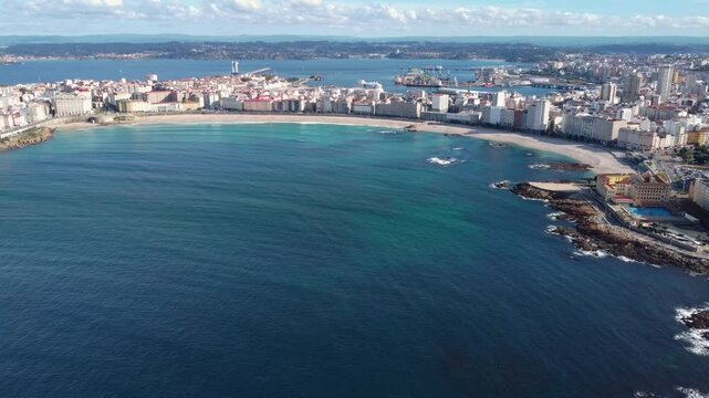 Panoramic aerial view of A Coruna city. Drone slowly descending above the bay. famous travel destination in Galicia - Spain. Historic city center. Port of A Coruna in background.