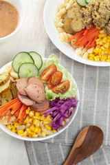 Salad, Colorful vegetarian bowls filled with pasta, fresh veggies, and protein arranged neatly on a dining table with wooden utensils