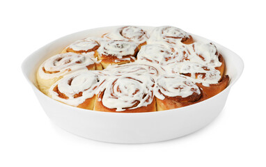 Delicious frosted cinnamon rolls in baking dish isolated on white