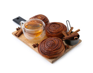 Delicious cinnamon roll buns with tea and spices isolated on white
