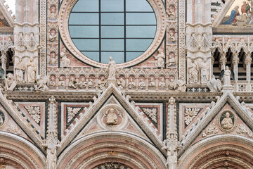 Obraz premium Facade of the Siena Cathedral. It's a medieval church dedicated from its earliest days as Roman Catholic Marian church. The cathedral was completed in 1263. Italy, 2019
