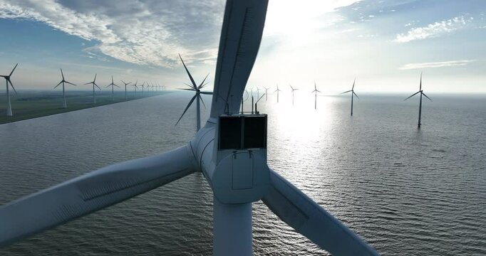 Offshore wind farm, modern windmills, wind turbines, intended to generate wind energy. Placement in the sea, high-voltage installation
