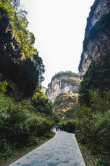 chongqing.china 24.03.2024 Tourists walking along a scenic nature trail at the breathtaking Three Natural Bridges in Wulong Karst National Geopark, Wulong City, China.