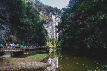 chongqing.china 24.03.2024 Tourists walking along a scenic nature trail at the breathtaking Three Natural Bridges in Wulong Karst National Geopark, Wulong City, China.
