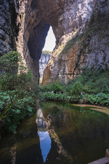 The breathtaking natural beauty of a stunning sinkhole within the Three Natural Bridges at Wulong Karst National Geopark, Wulong City, China.