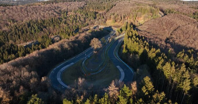 Aerial views on Caracciola Karussell corner at the Nurburgring, famous race track in the german eifel.