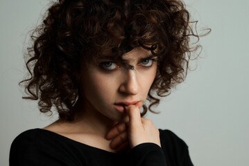 an emotional portrait of a beautiful curly-haired girl